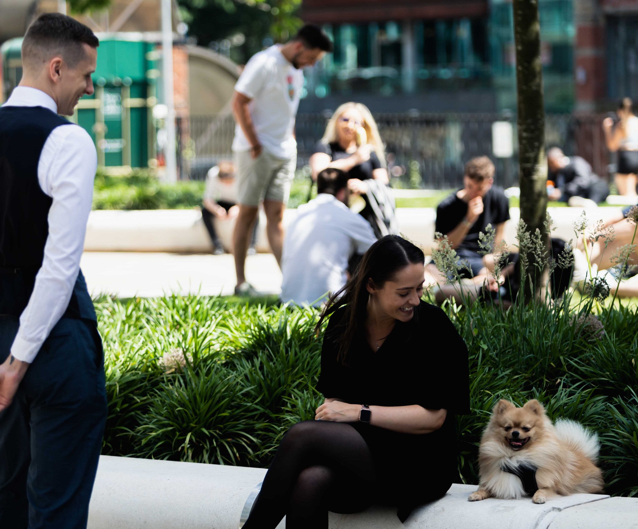 Person and dog sitting on a bench