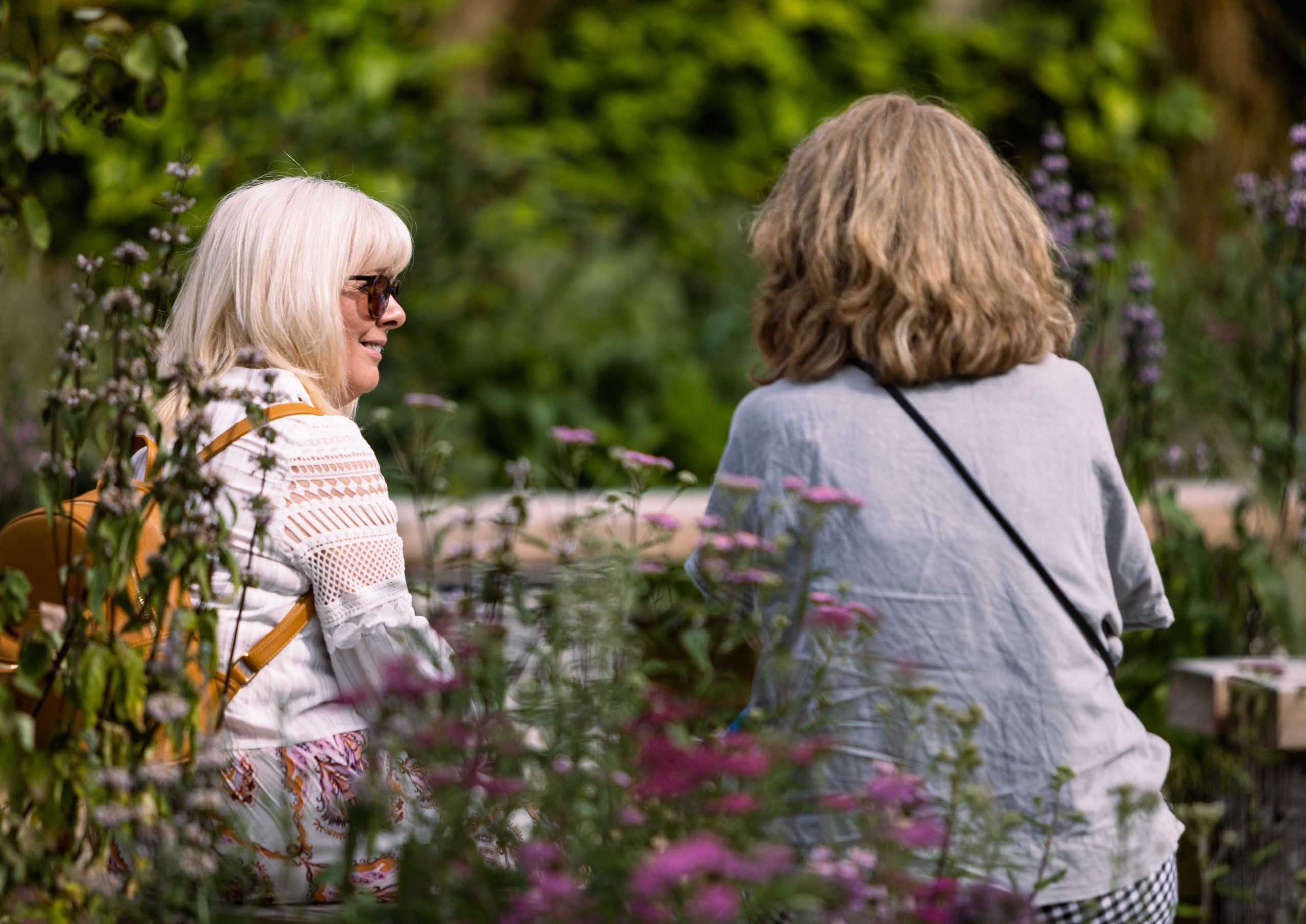 Two people sat talking in greenspace